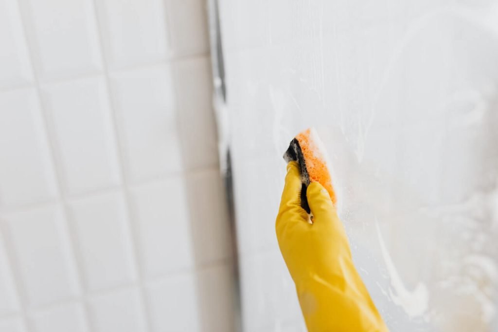 cleaning Glass Shower Doors with a sponge
